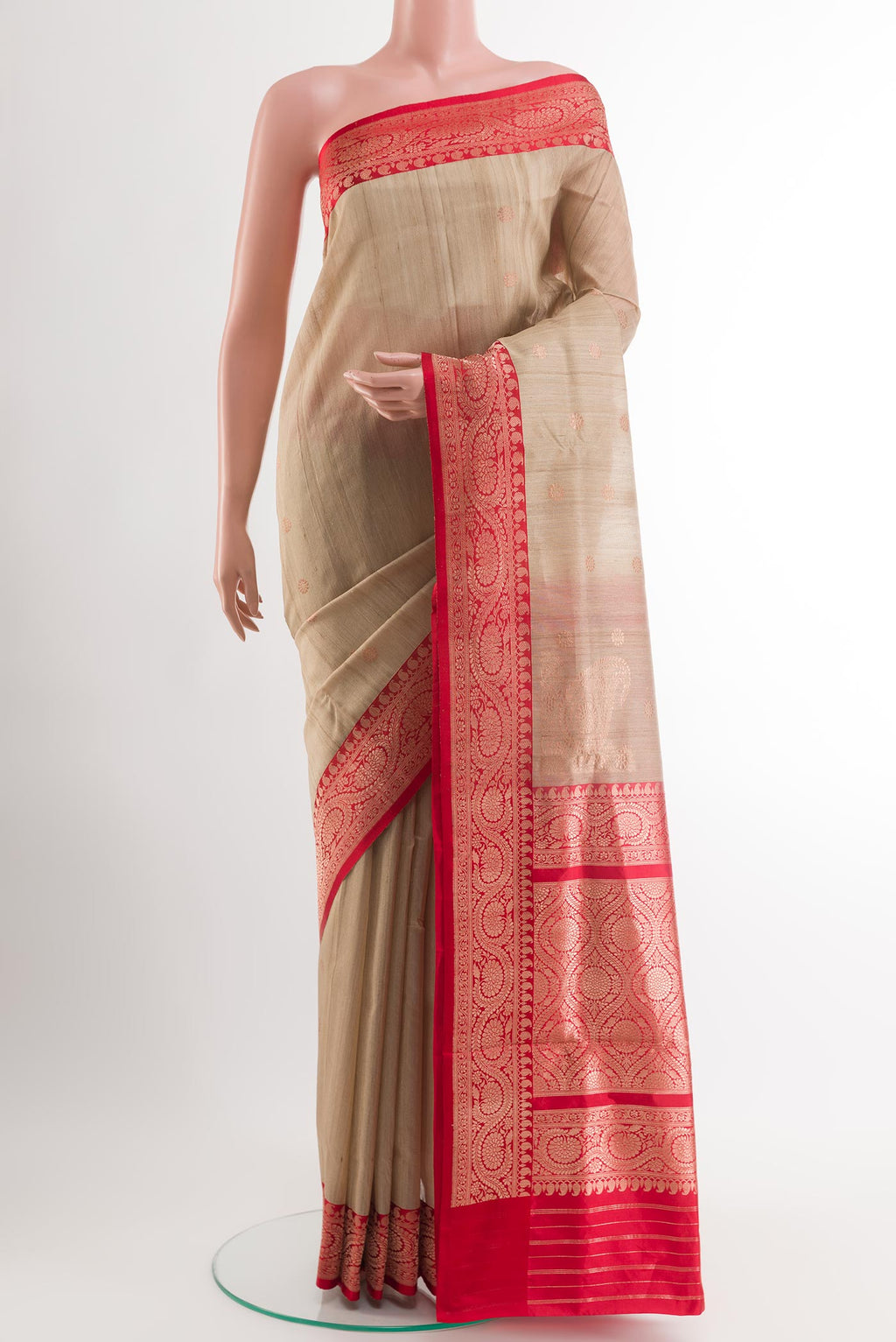 Beige Banarasi Tussar Silk Saree with Zari Butta on the body and Zari Border.  displayed on a mannequin