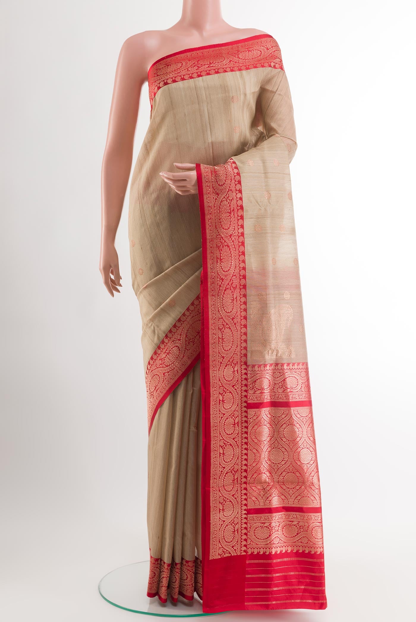 Beige Banarasi Tussar Silk Saree with Zari Butta on the body and Zari Border.  displayed on a mannequin