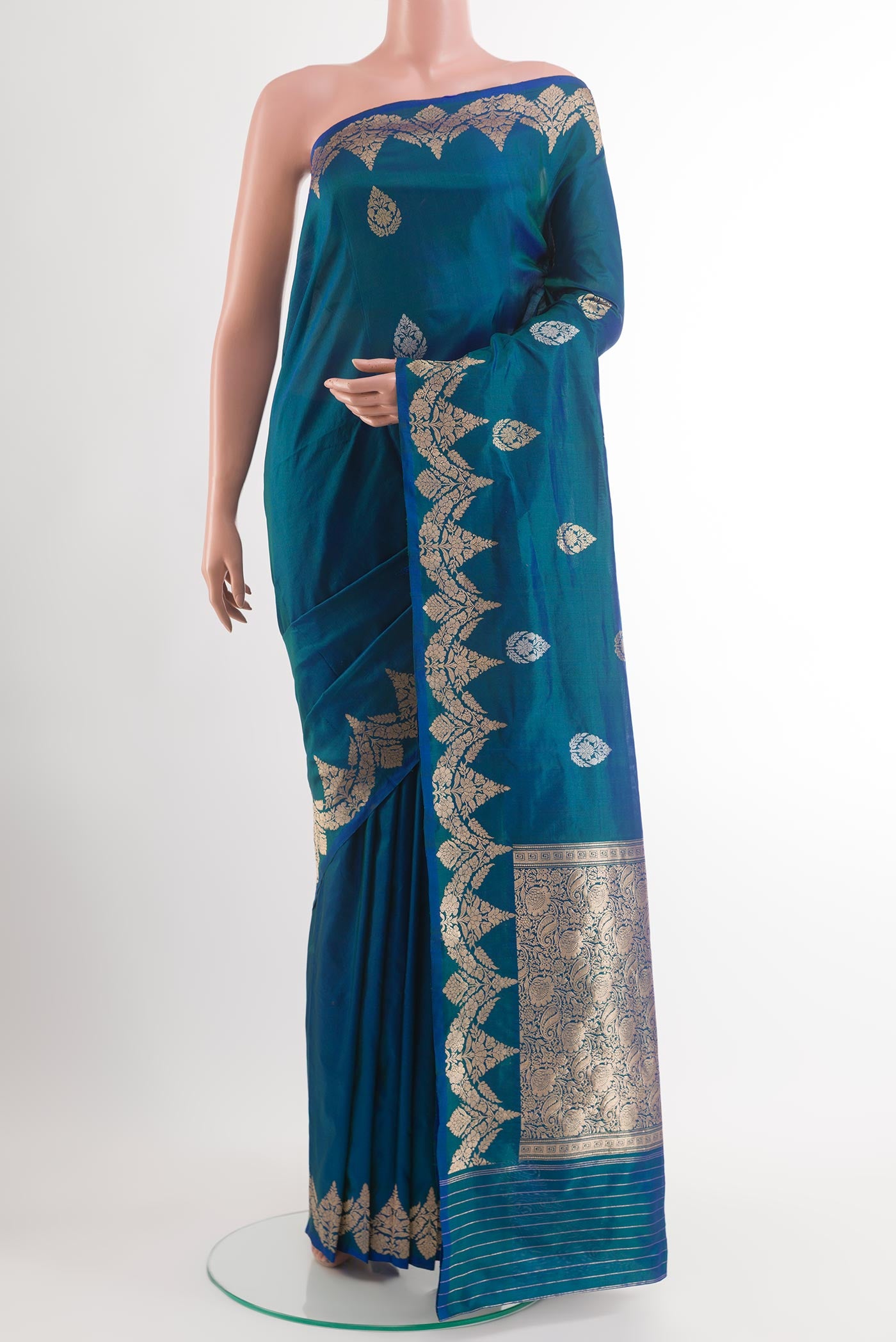 Blue Banarasi Katan Silk Saree with Zari Butta on the body and Zari Border.  displayed on a mannequin