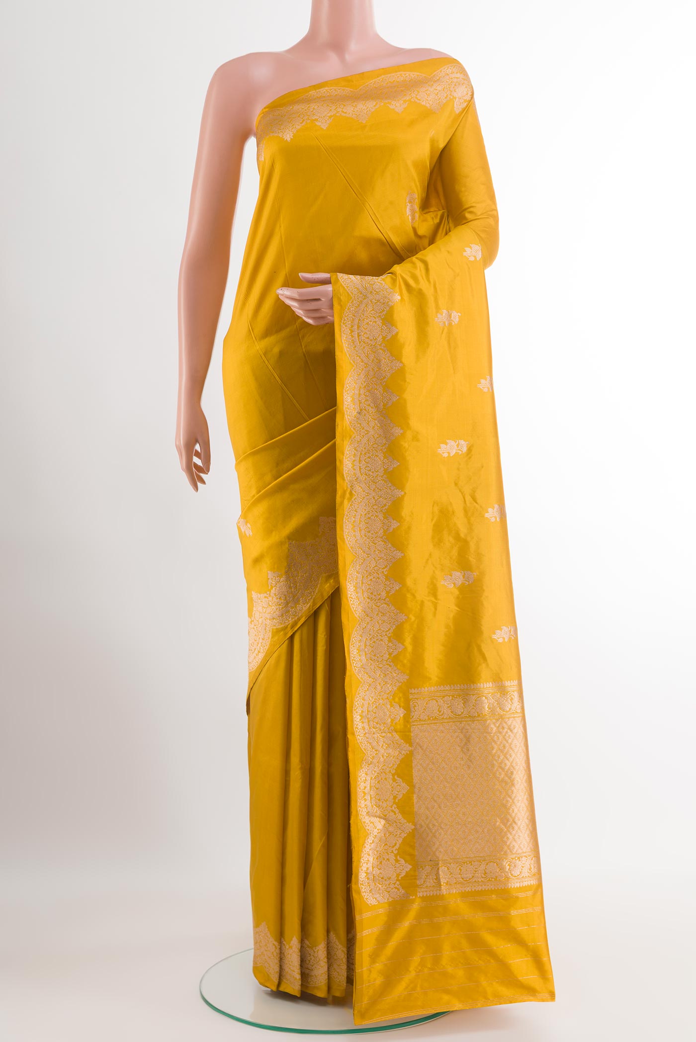 Yellow Banarasi Katan Silk Saree with Zari Butta on the body and Zari Border.  displayed on a mannequin