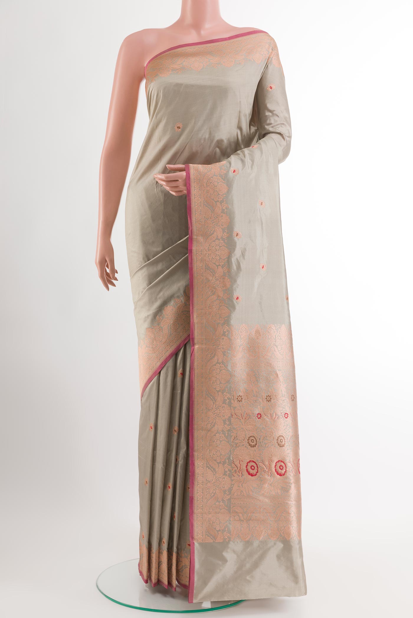 Grey Banarasi Katan Silk Saree with Zari Butta on the body and Zari Border.  displayed on a mannequin
