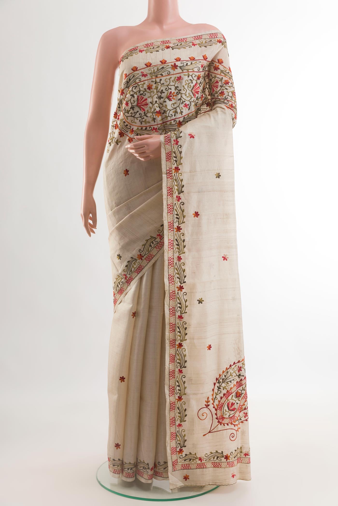 Beige Tussar Silk Saree with Embroidery on the body and Embroidery Border.  displayed on a mannequin