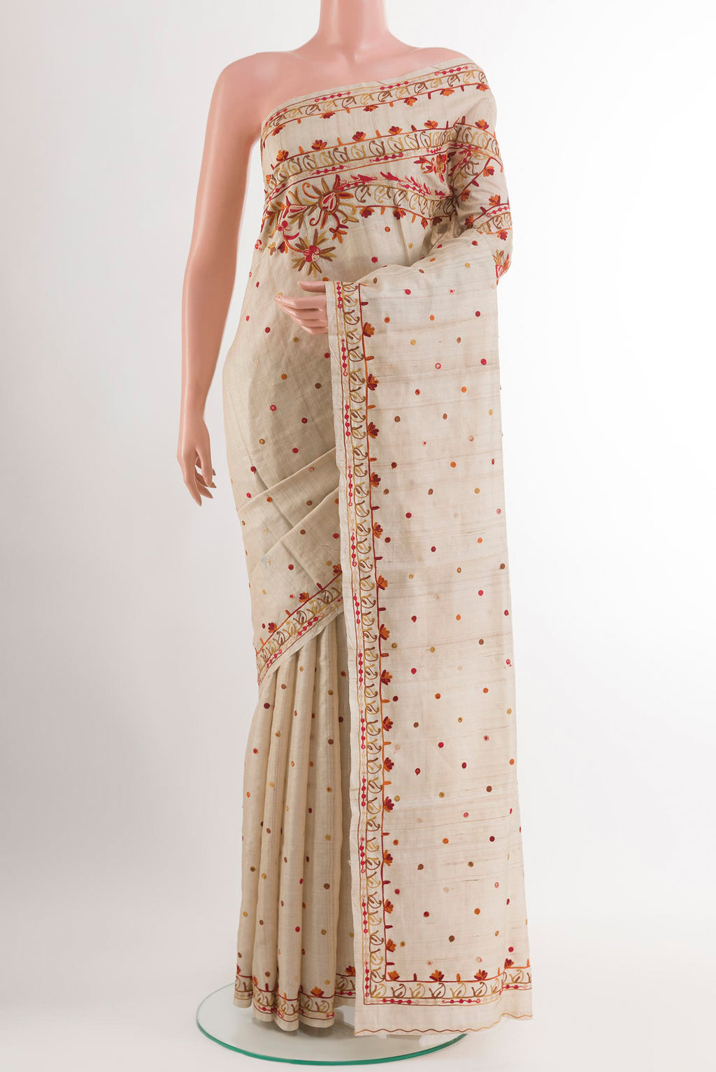 Off White Tussar Saree with Embroidery on the body and Embroidery Border.  displayed on a mannequin