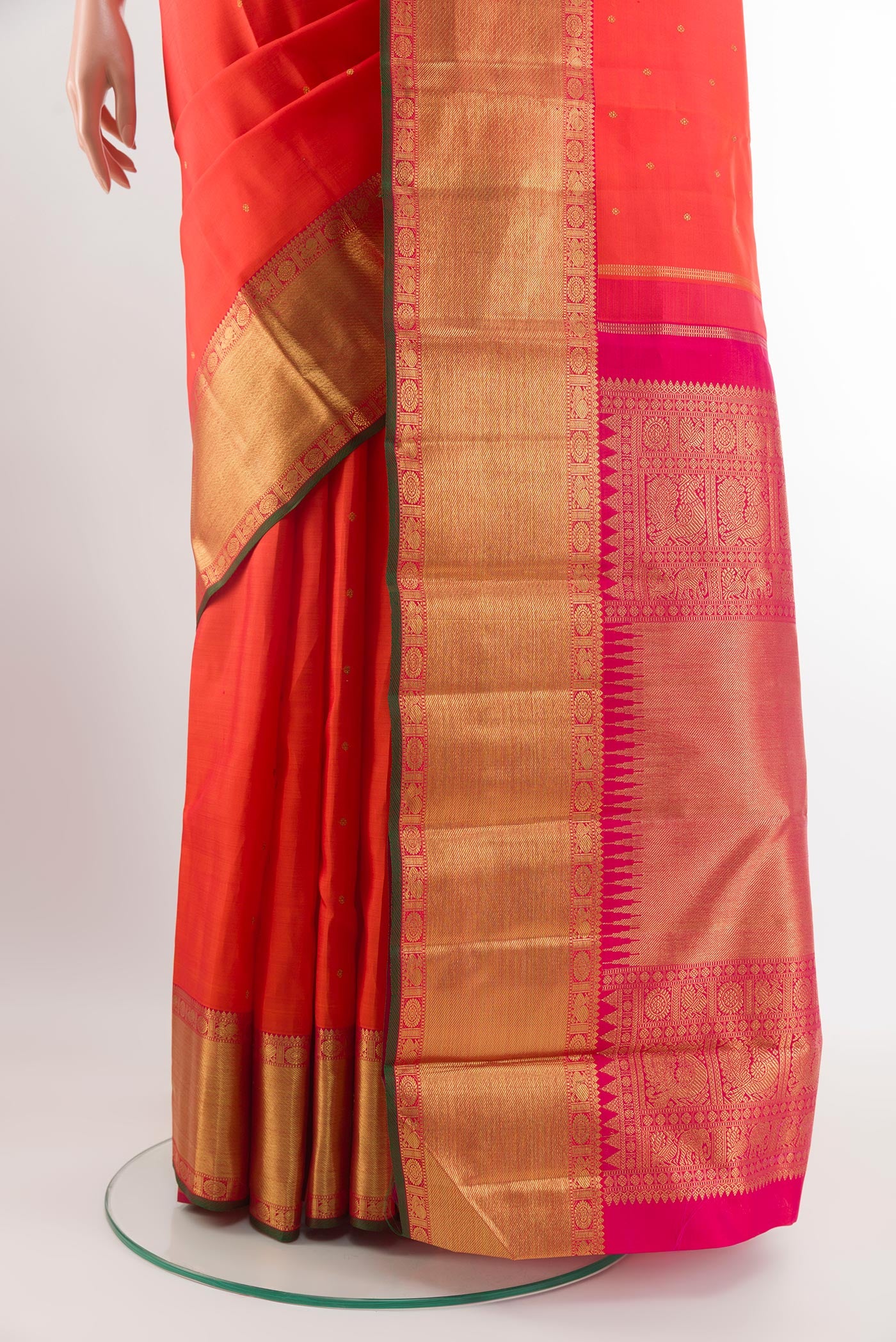Pleats and pallu of Pure Silk Pure Zari Orange Kanjivaram Saree with Zari Butta on the body and Zari Border. 