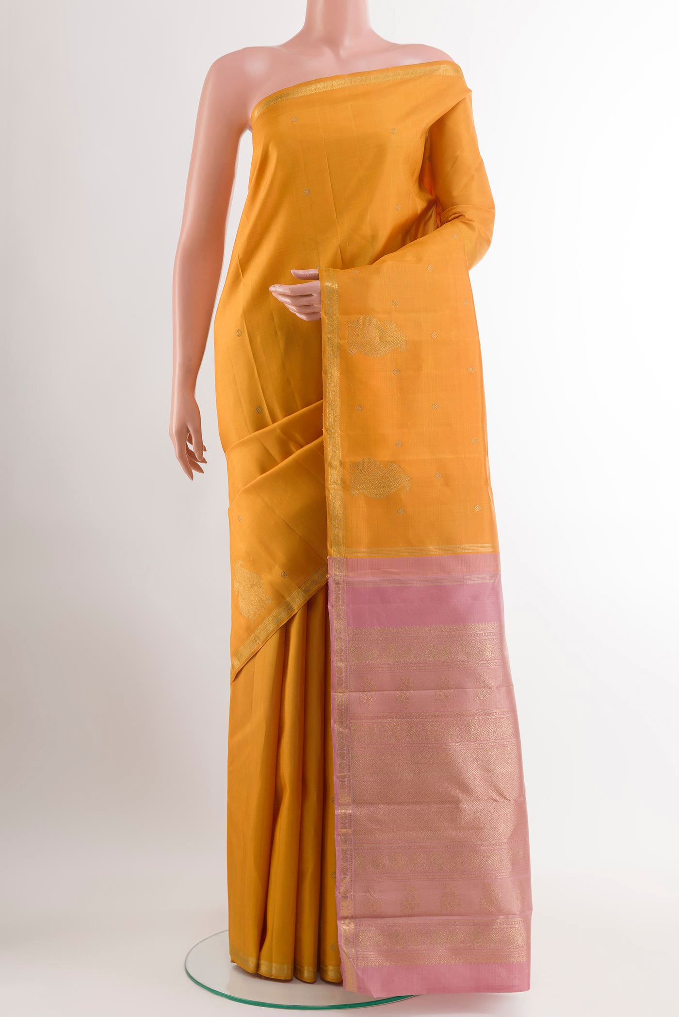 Yellow Kanchipuram Silk Saree with Zari Butta on the body and Zari Border.  displayed on a mannequin