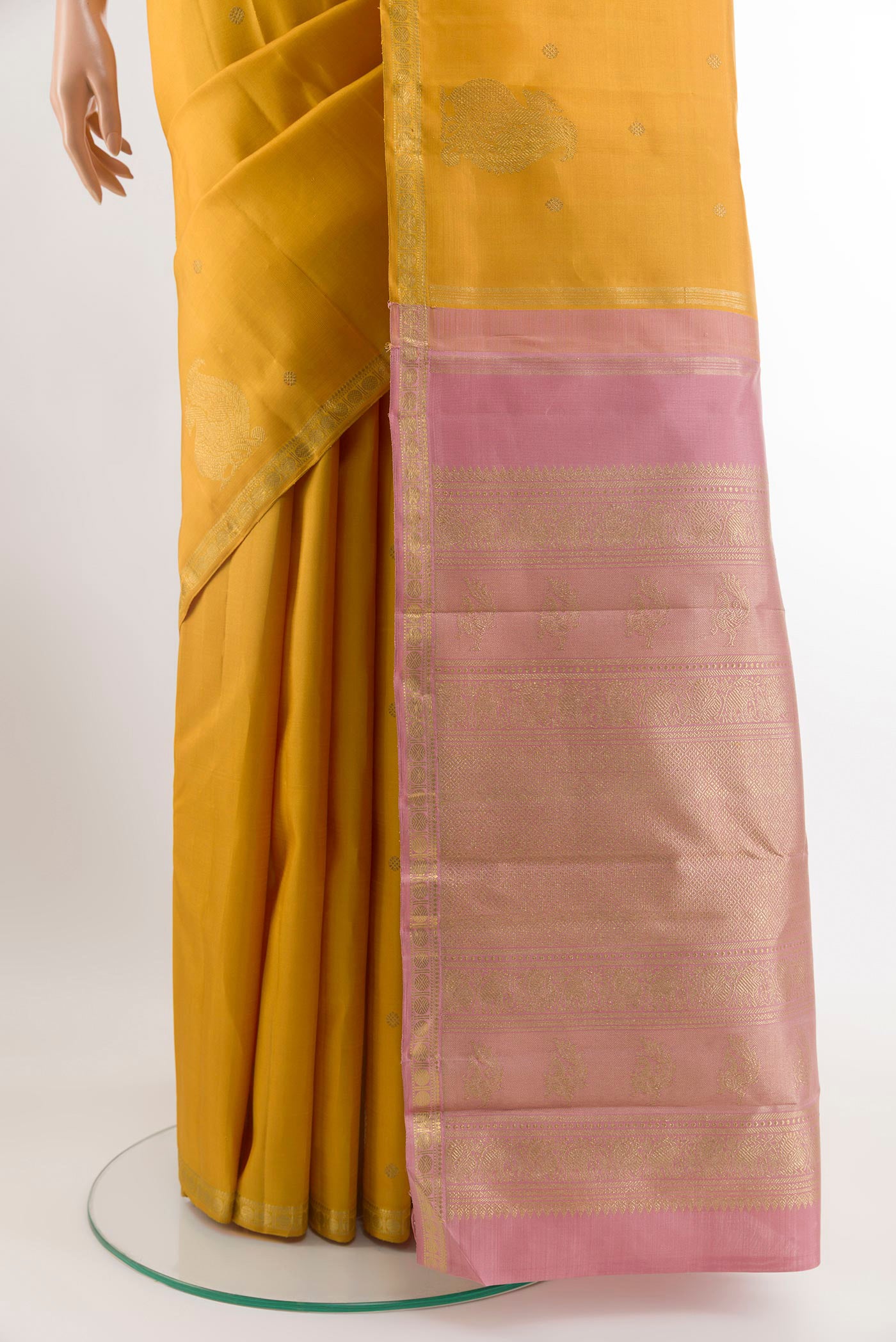 Pleats and pallu of Yellow Kanchipuram Silk Saree with Zari Butta on the body and Zari Border. 