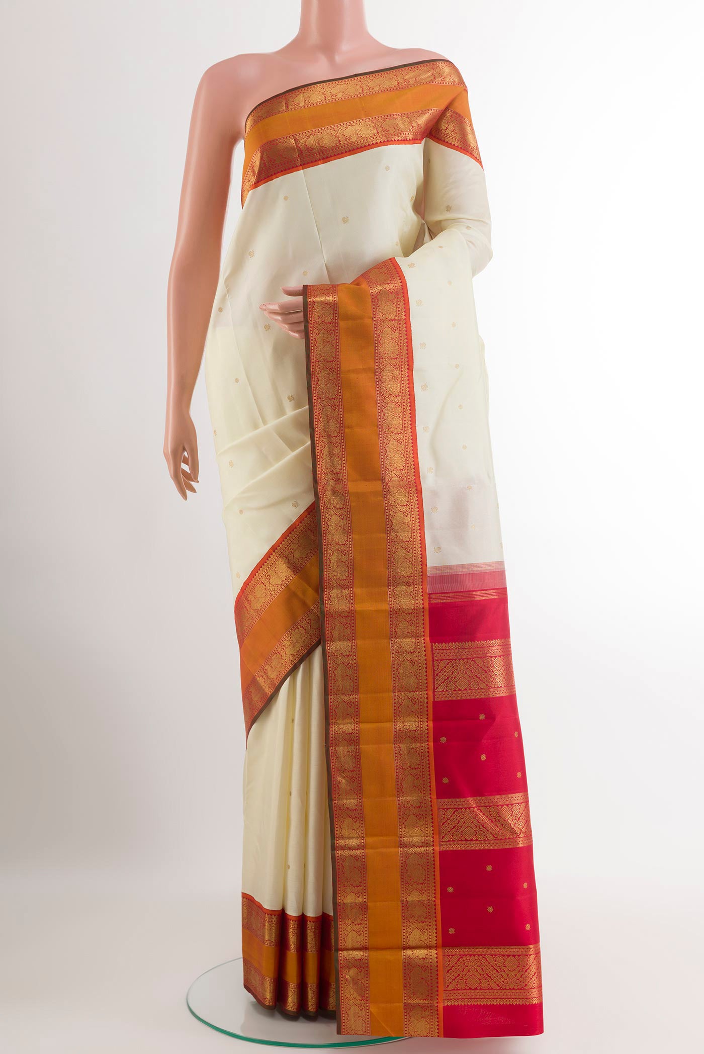 Off White Kanjivaram Silk Saree with Zari Butta on the body and Zari Border.  displayed on a mannequin