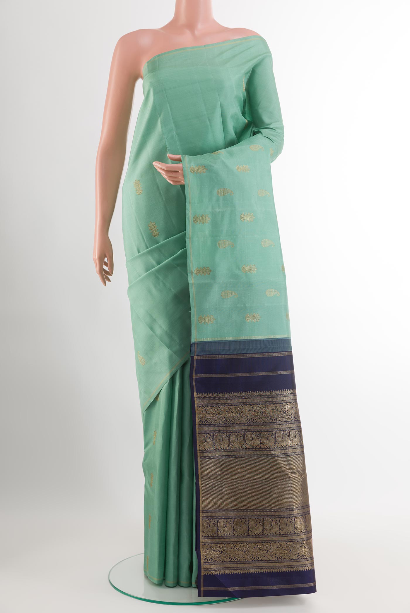Pure Silk Pure Zari Light Blue Kanchipuram Saree with Zari Butta on the body and Zari Border.  displayed on a mannequin