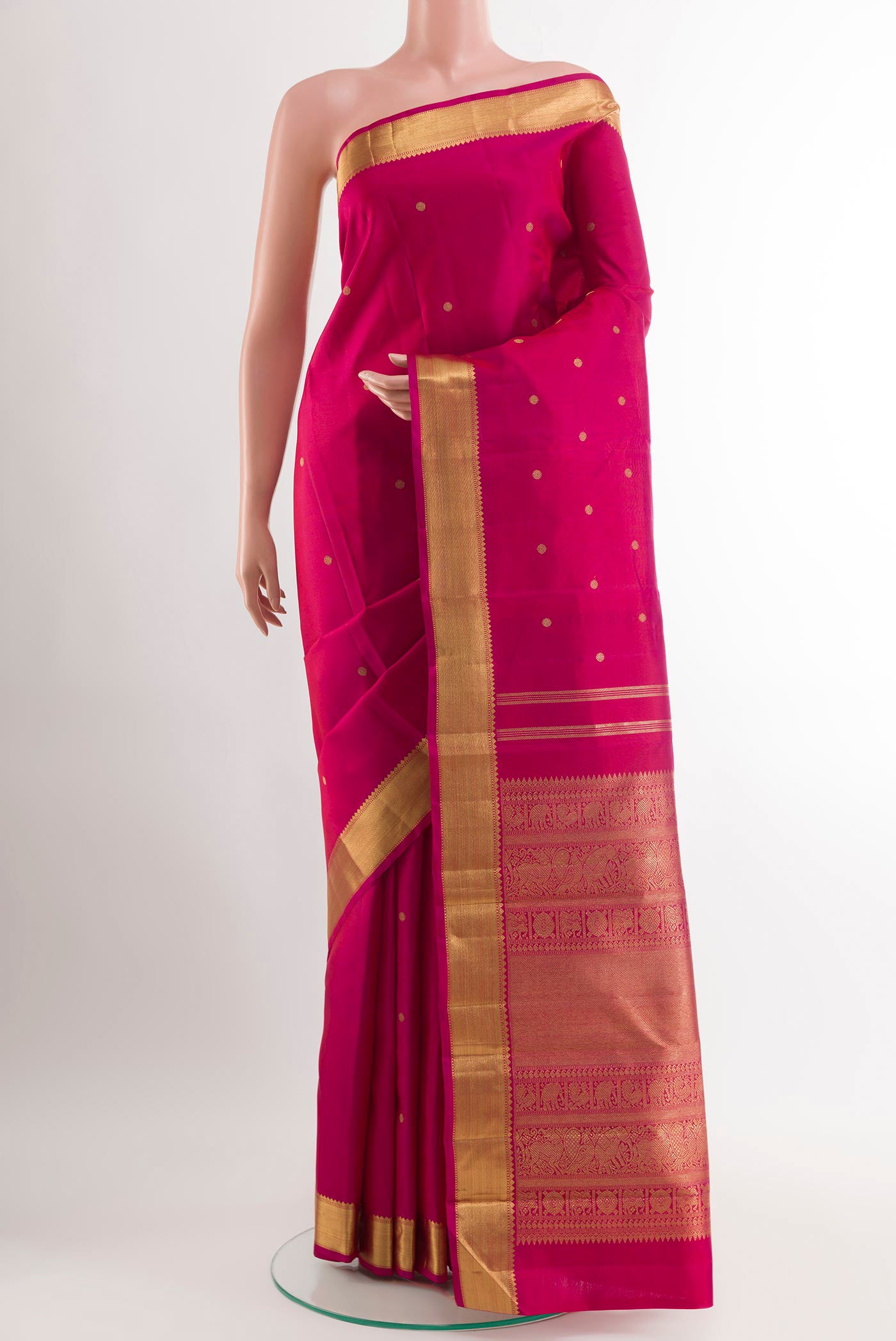 Rani Pink Dual Tone Kanjivaram Silk Saree with Zari Butta on the body and Zari Border.  displayed on a mannequin