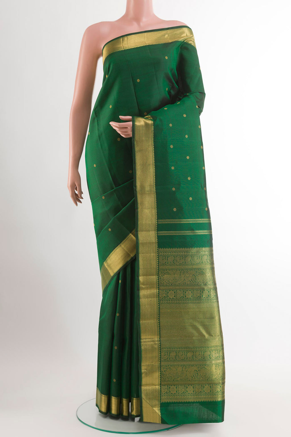 Green Kanjivaram Silk Saree with Zari Butta on the body and Zari Border.  displayed on a mannequin