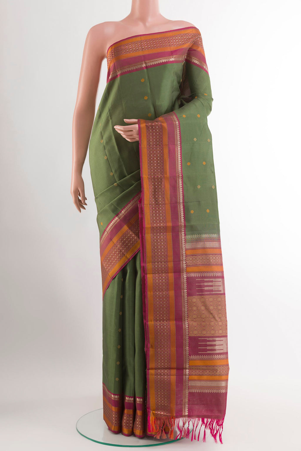 Green Kanchipuram Silk Saree with Zari Butta on the body and Zari Border.  displayed on a mannequin