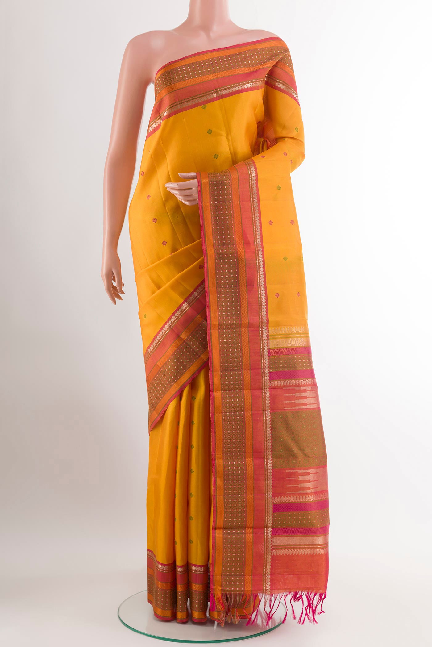 Yellow Kanchipuram Silk Saree with Thread Butta on the body and Zari Border.  displayed on a mannequin