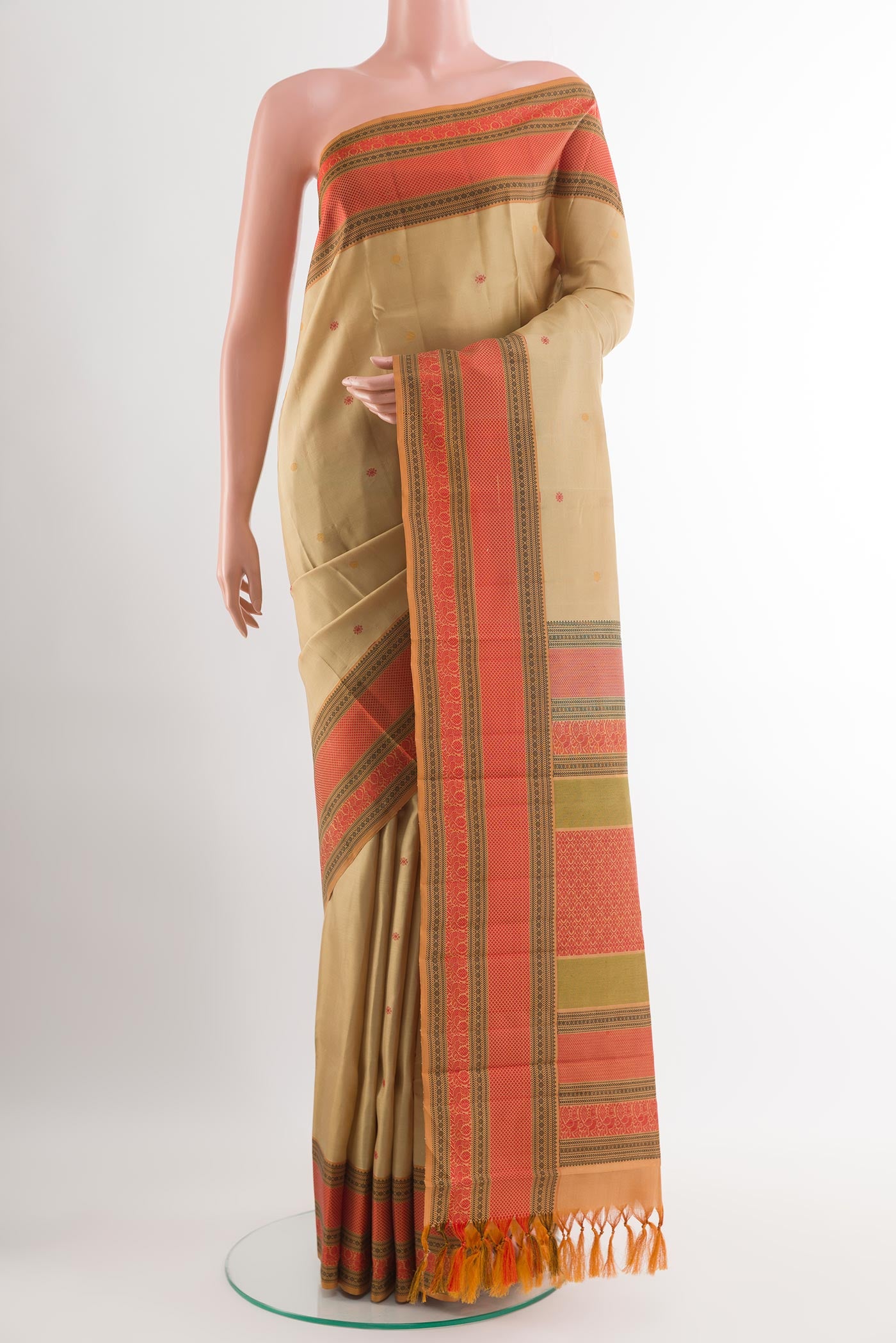 Beige Kanchipuram Silk Saree with Thread Butta on the body and Thread Embroidery Border.  displayed on a mannequin