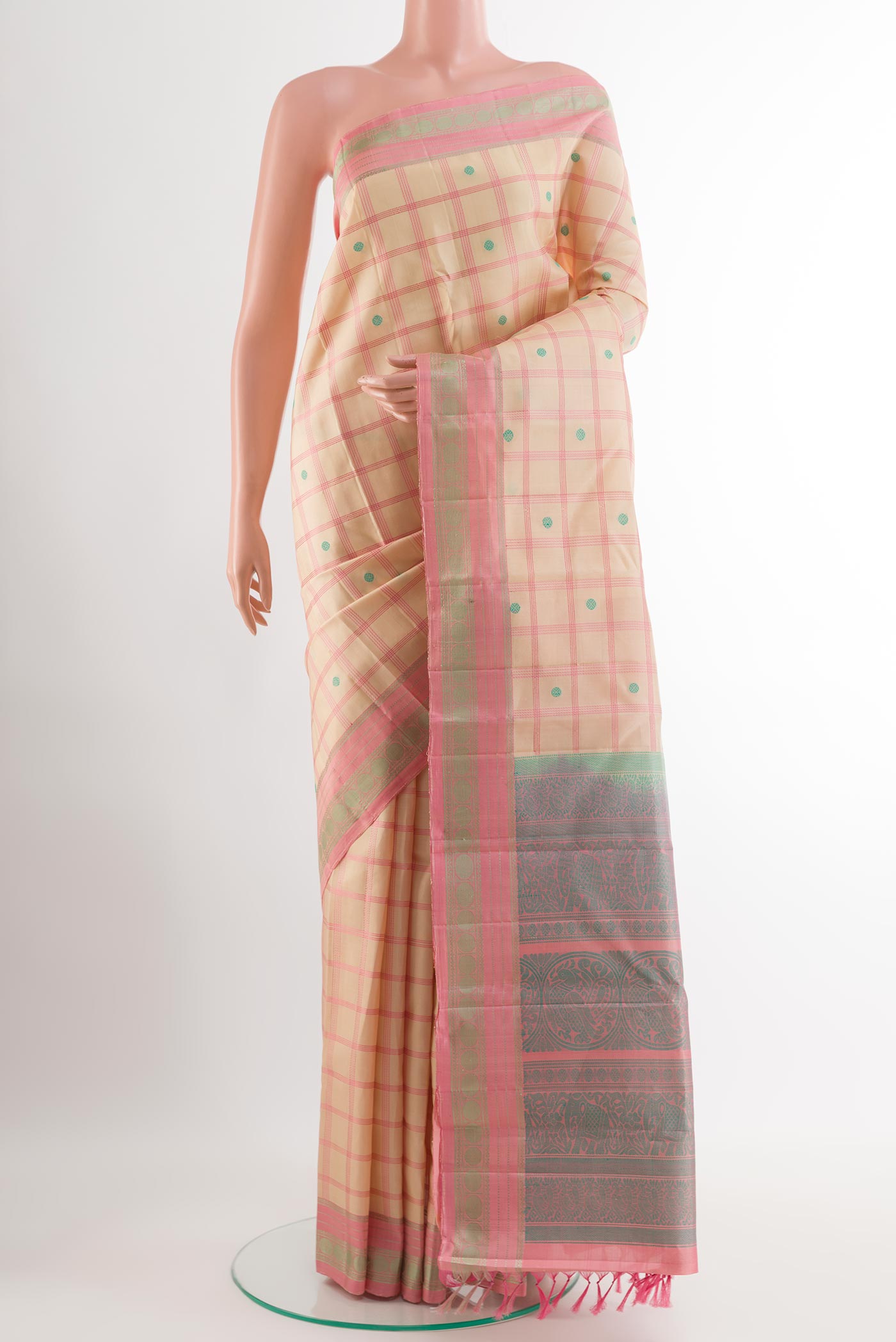 Cream Kanchipuram Silk Saree with Thread Butta on the body and Thread Embroidery Border.  displayed on a mannequin