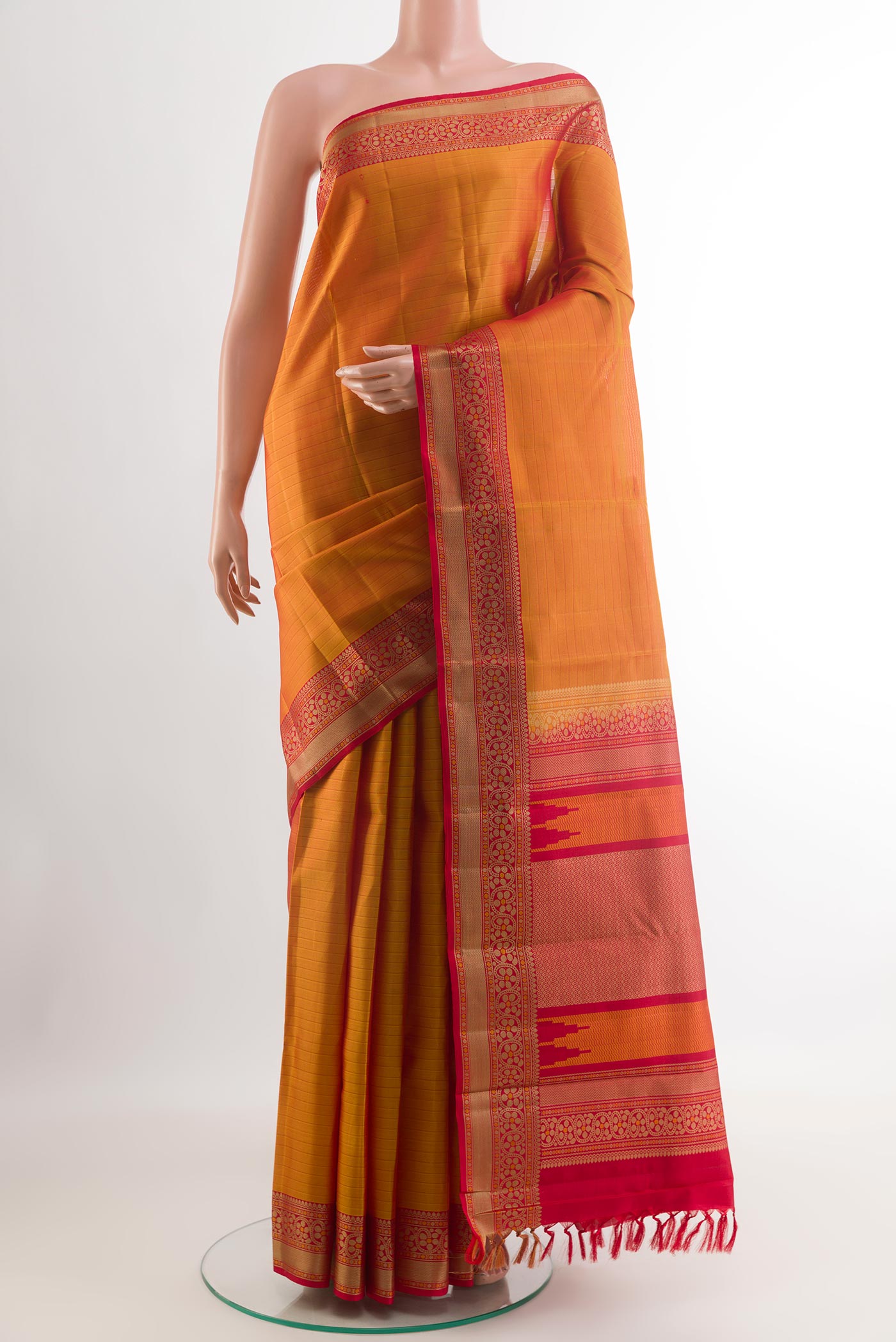 Orange Kanchipuram Silk Saree with Stripes on the body and Zari Border.  displayed on a mannequin