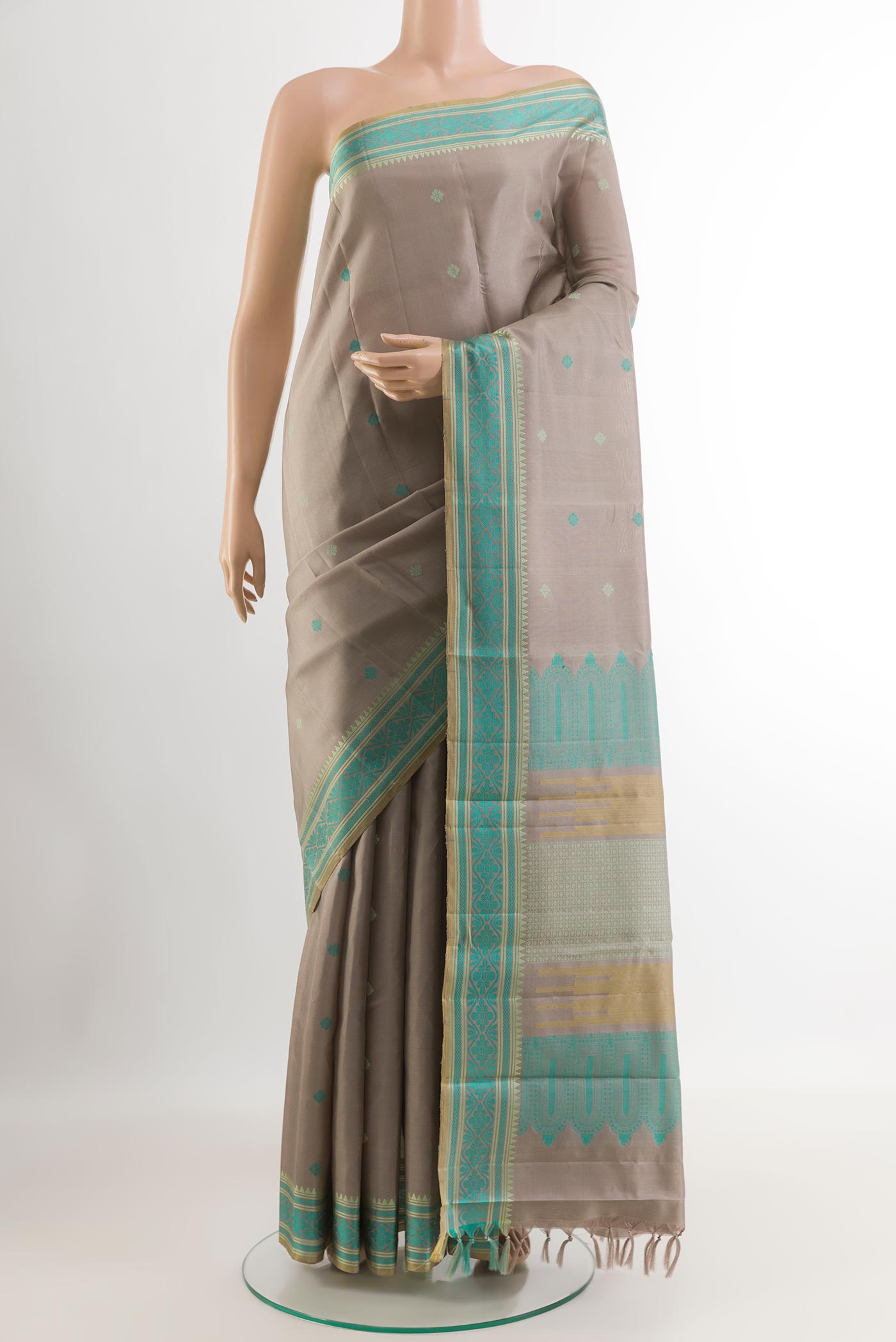 Grey Kanchipuram Silk Saree with Thread Butta on the body and Without Border.  displayed on a mannequin