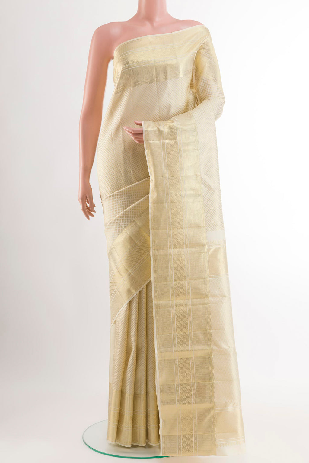 Off White Kanchipuram Silk Saree with Zari Brocade on the body and Zari Border.  displayed on a mannequin