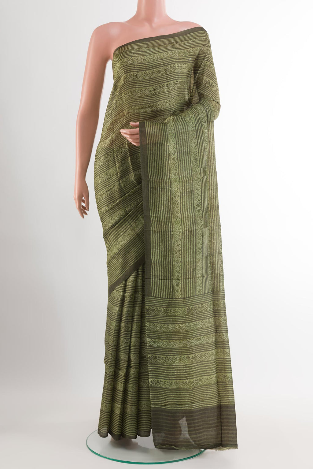 Green Tussar Saree with Printed design on the body and Printed Border.  displayed on a mannequin