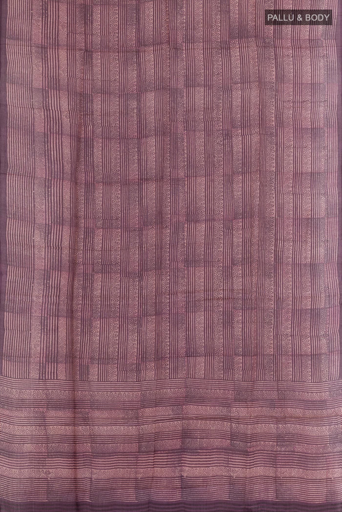 Flat view of Purple Tussar Saree with Printed design on the body and Printed Border. 