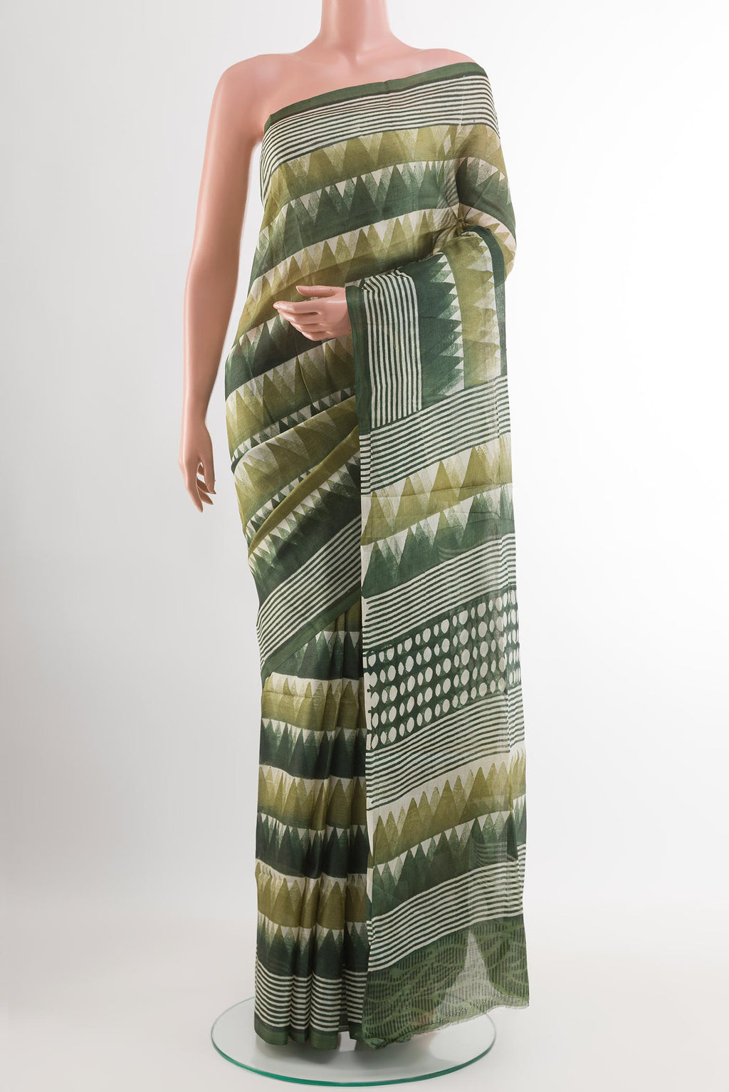 Green Tussar Saree with Printed design on the body and Printed Border.  displayed on a mannequin