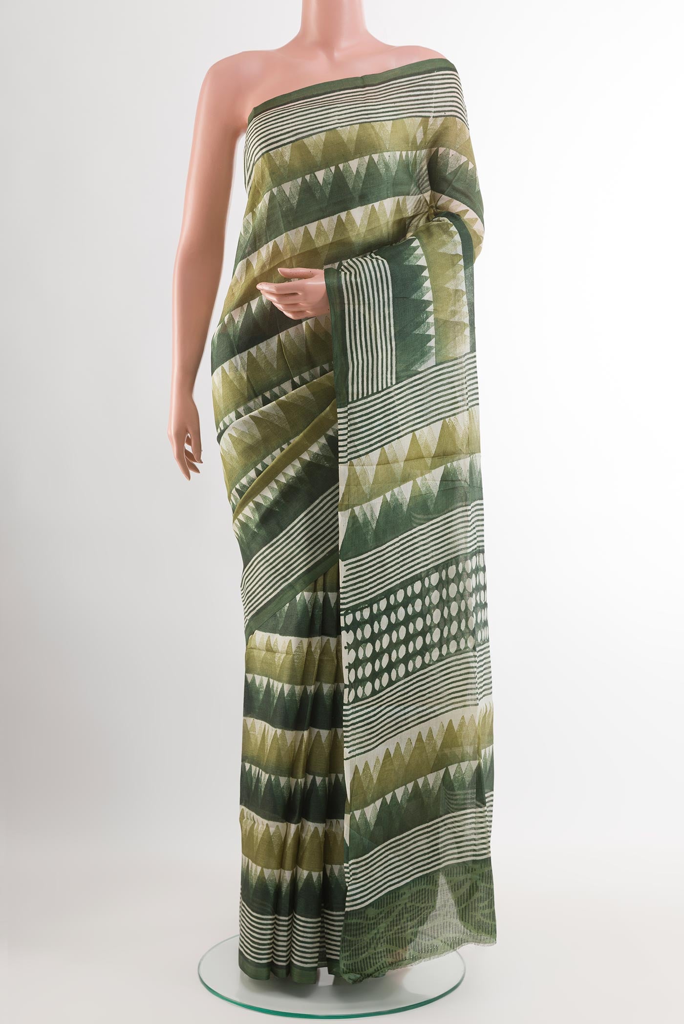Green Tussar Saree with Printed design on the body and Printed Border.  displayed on a mannequin