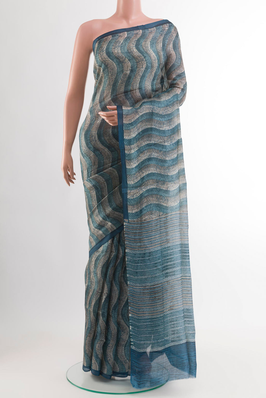 Blue Tussar Saree with Printed design on the body and Zari Border.  displayed on a mannequin