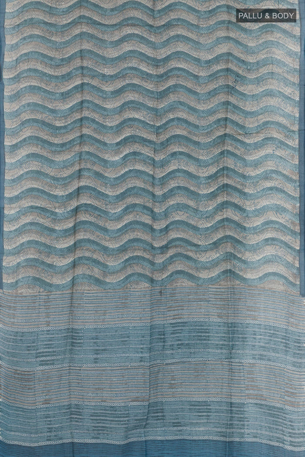 Flat view of Blue Tussar Saree with Printed design on the body and Zari Border. 
