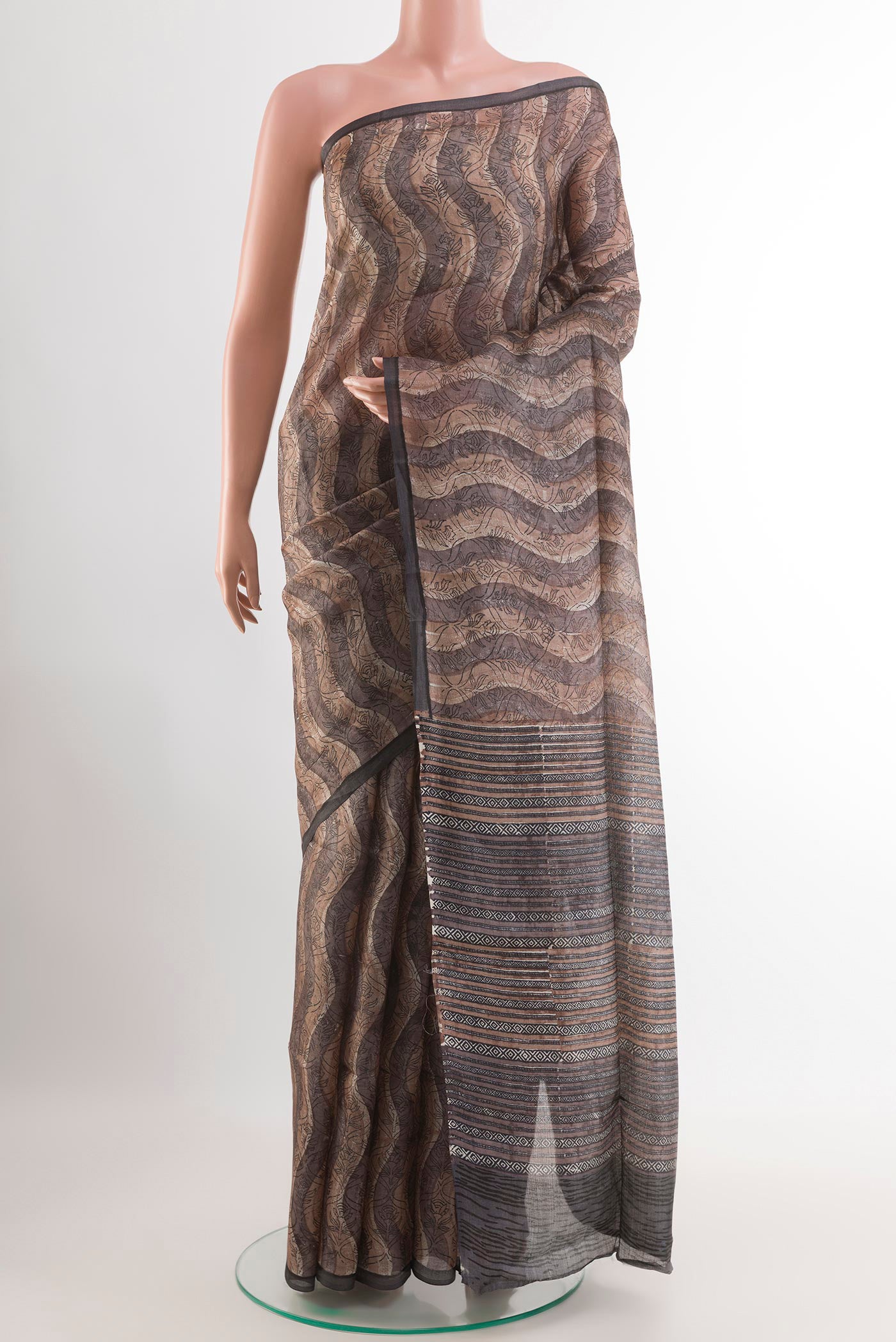 Grey Tussar Saree with Printed design on the body and Printed Border.  displayed on a mannequin