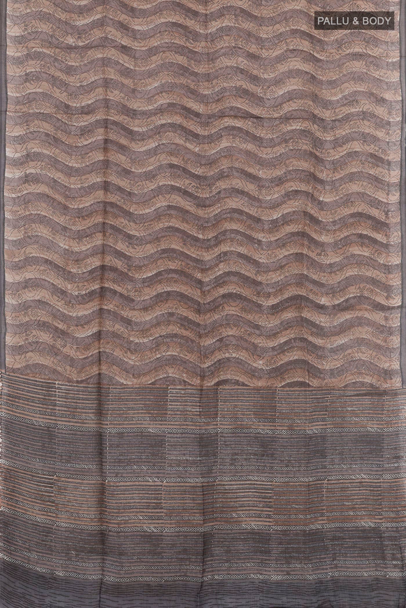 Flat view of Grey Tussar Saree with Printed design on the body and Printed Border. 