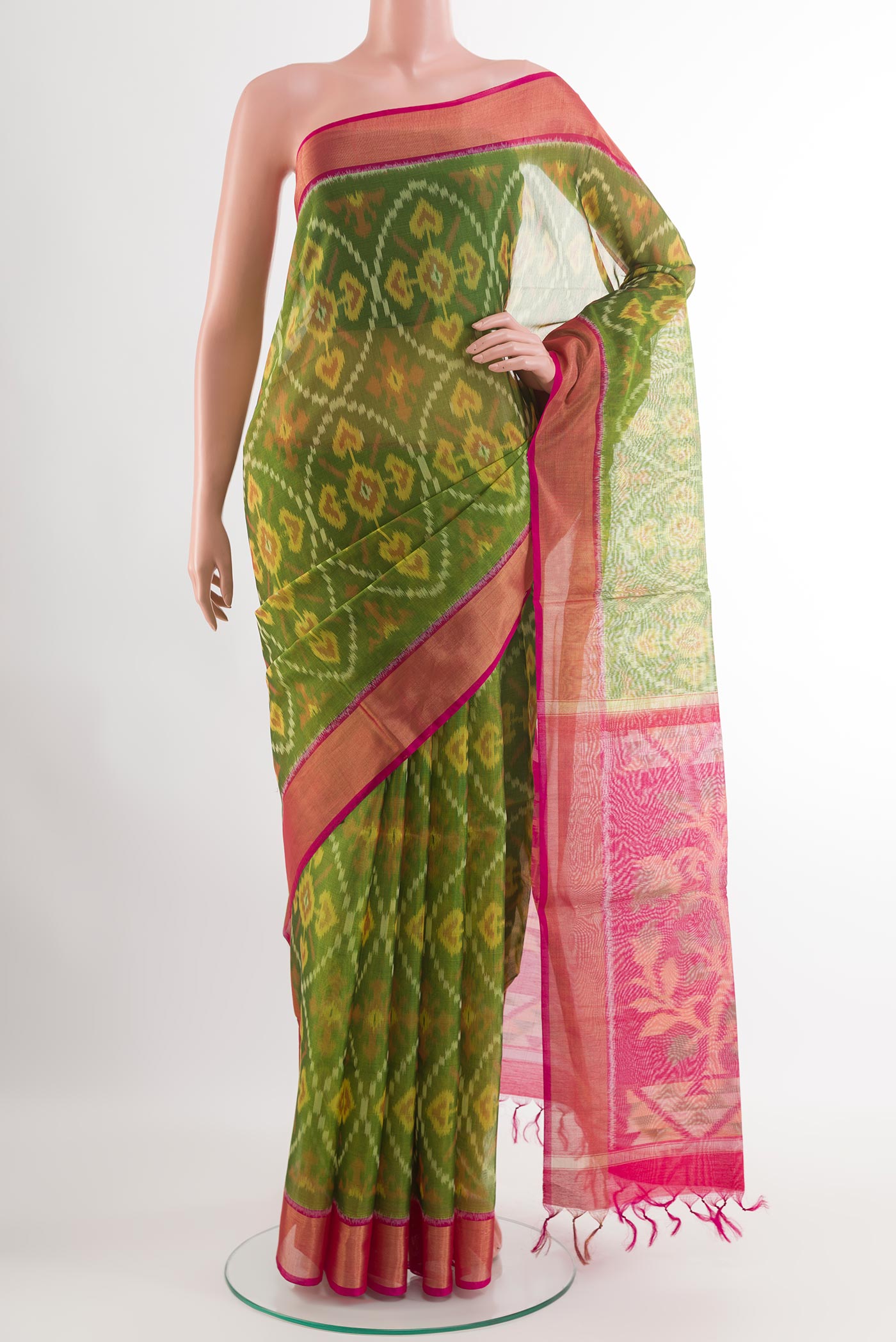 Green Blended Kora Cotton Saree with Ikat design on the body and Zari Border.  displayed on a mannequin