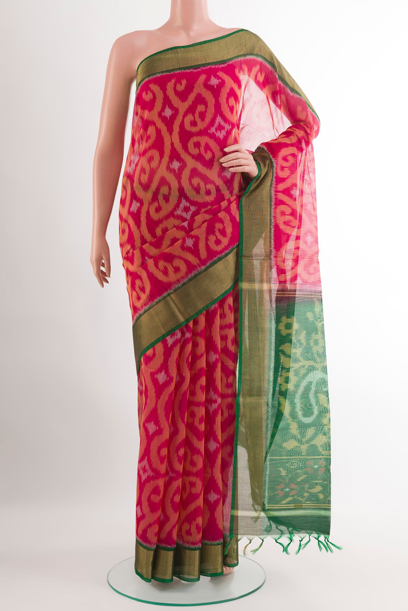 Pink Kora Cotton Saree with Ikat design on the body and Zari Border.  displayed on a mannequin