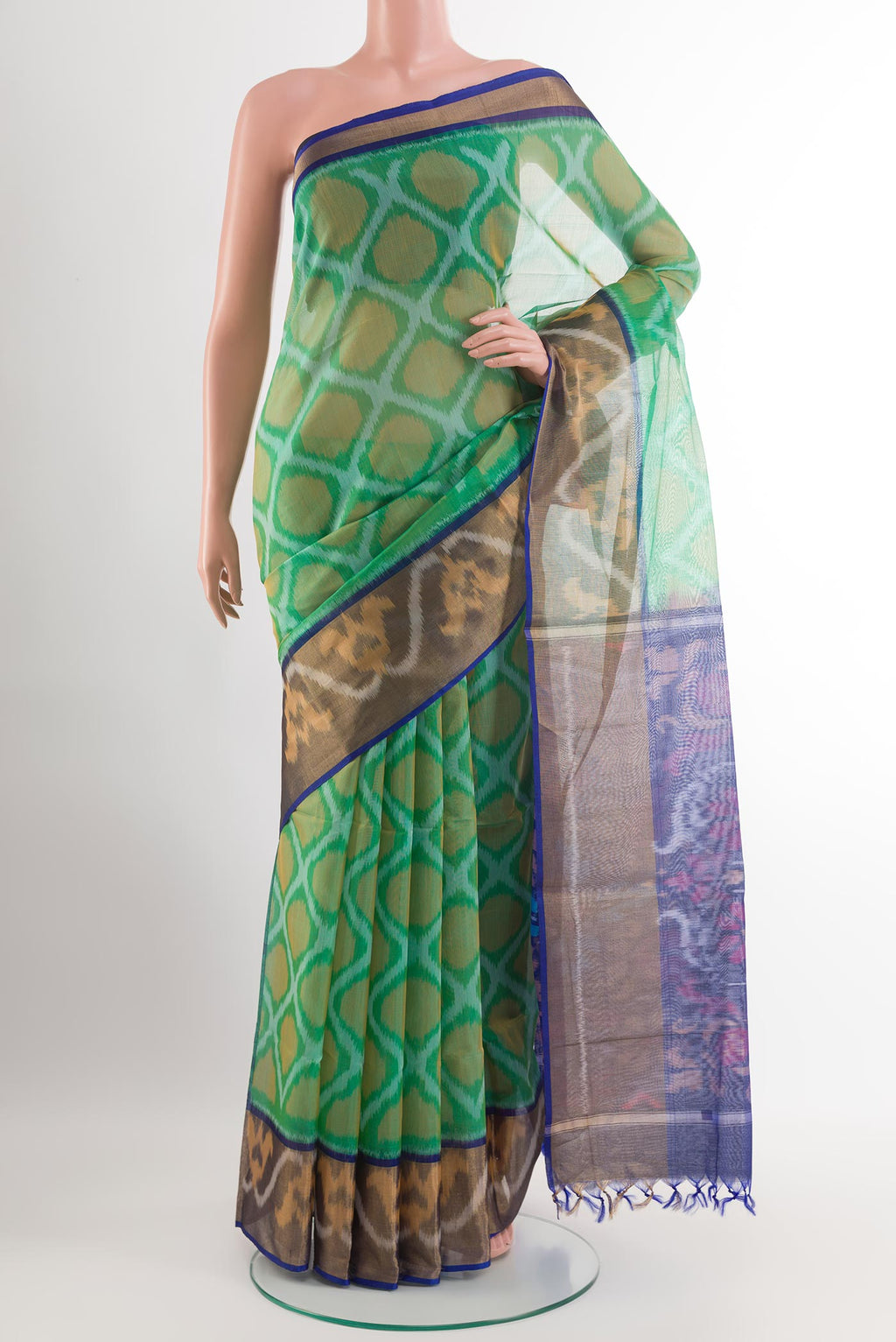 Green Blended Kora Cotton Saree with Ikat design on the body and Zari Border.  displayed on a mannequin