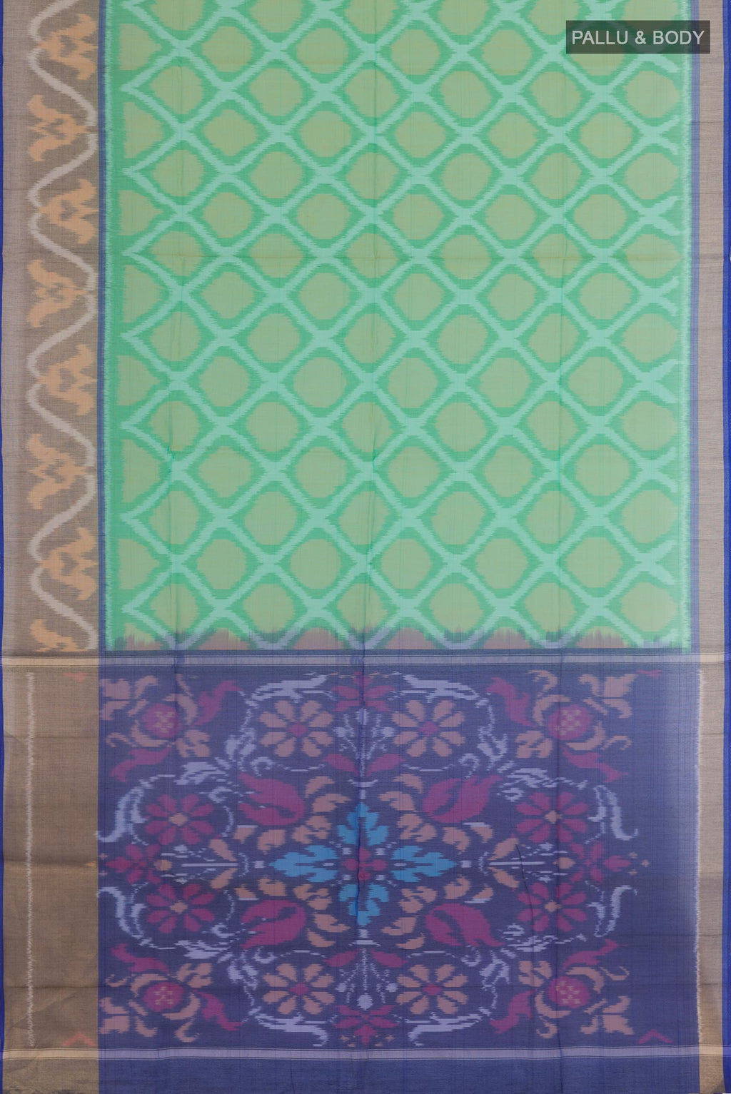 Flat view of Green Blended Kora Cotton Saree with Ikat design on the body and Zari Border. 