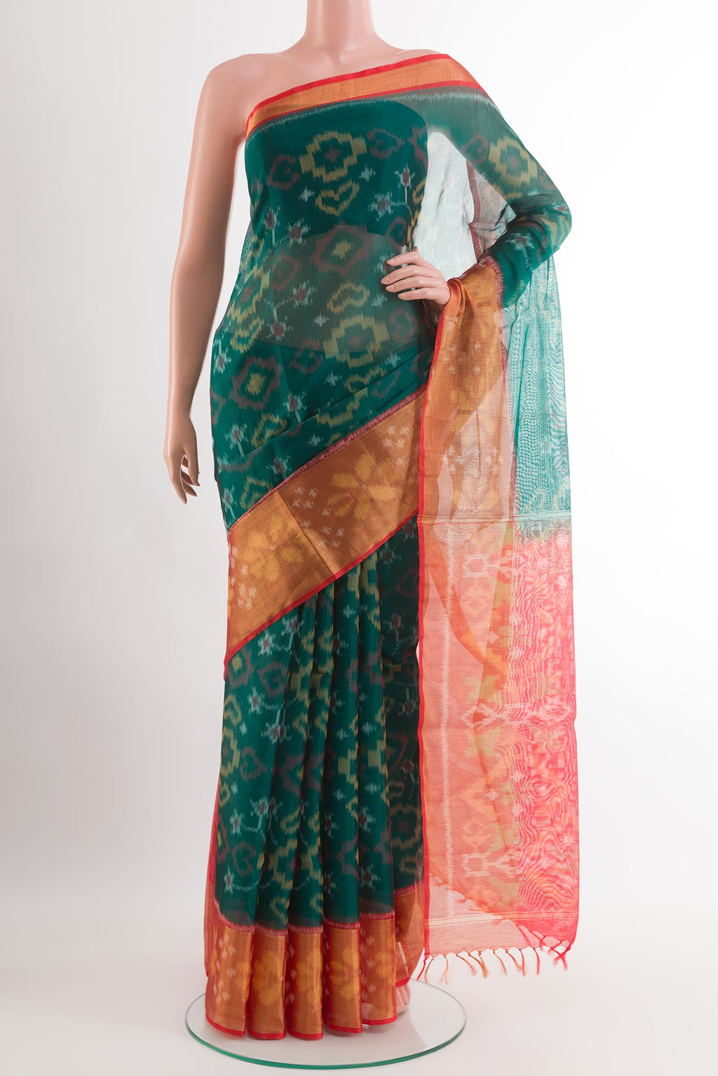 Green Blended Kora Cotton Saree with Ikat design on the body and Zari Border.  displayed on a mannequin