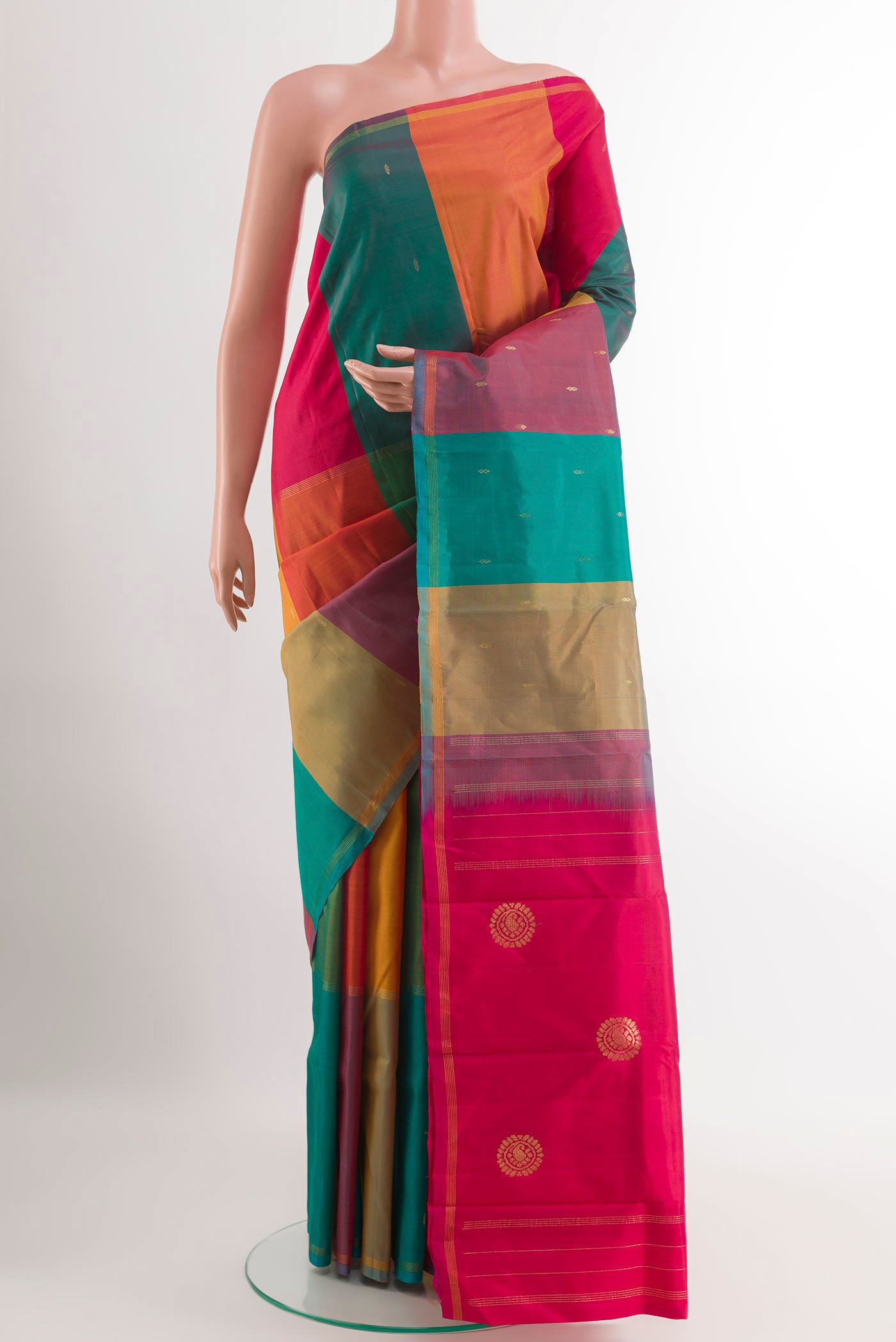 Multi Color Kanchipuram Silk Saree with Zari Butta on the body and Zari Border.  displayed on a mannequin