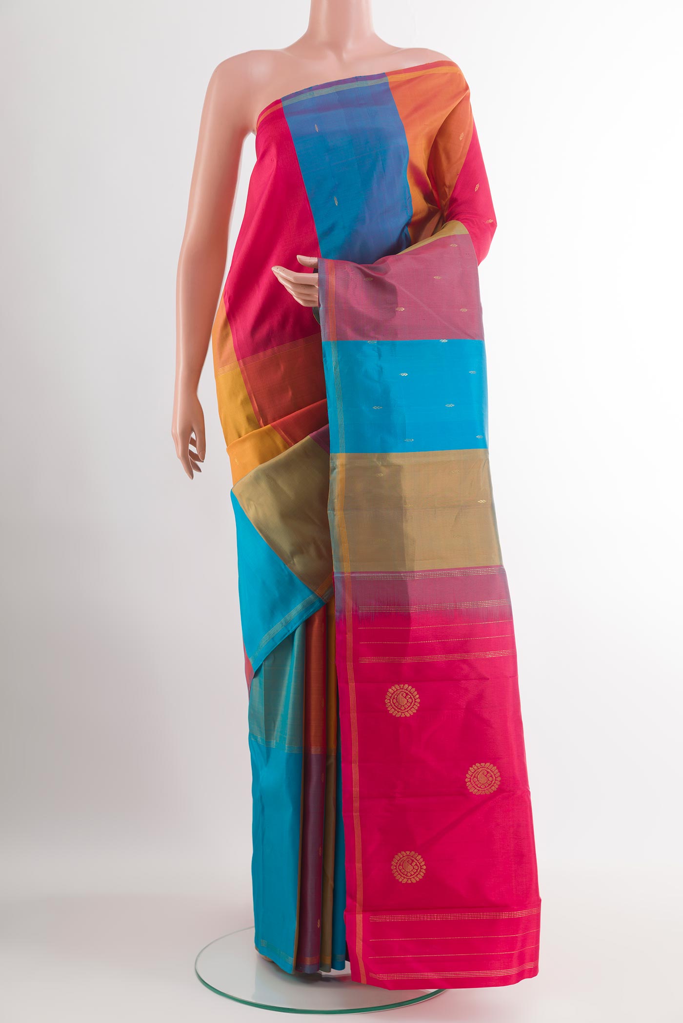 Multi Color Kanchipuram Silk Saree with Zari Butta on the body and Zari Border.  displayed on a mannequin