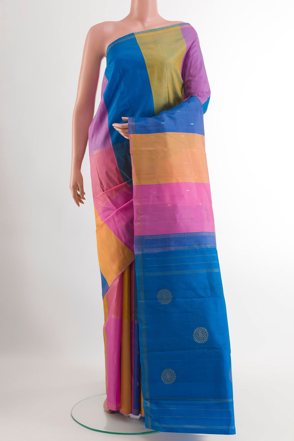 Multi Color Kanchipuram Silk Saree with Zari Butta on the body and Zari Border.  displayed on a mannequin