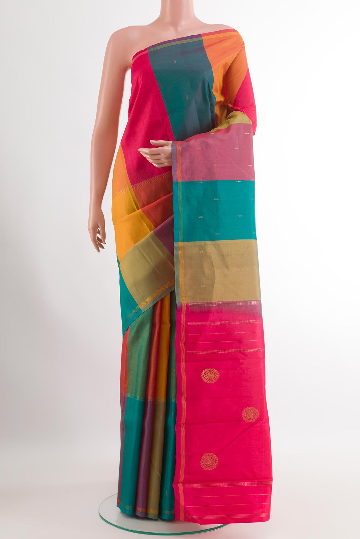 Multi Color Kanchipuram Silk Saree with Zari Butta on the body and Zari Border.  displayed on a mannequin