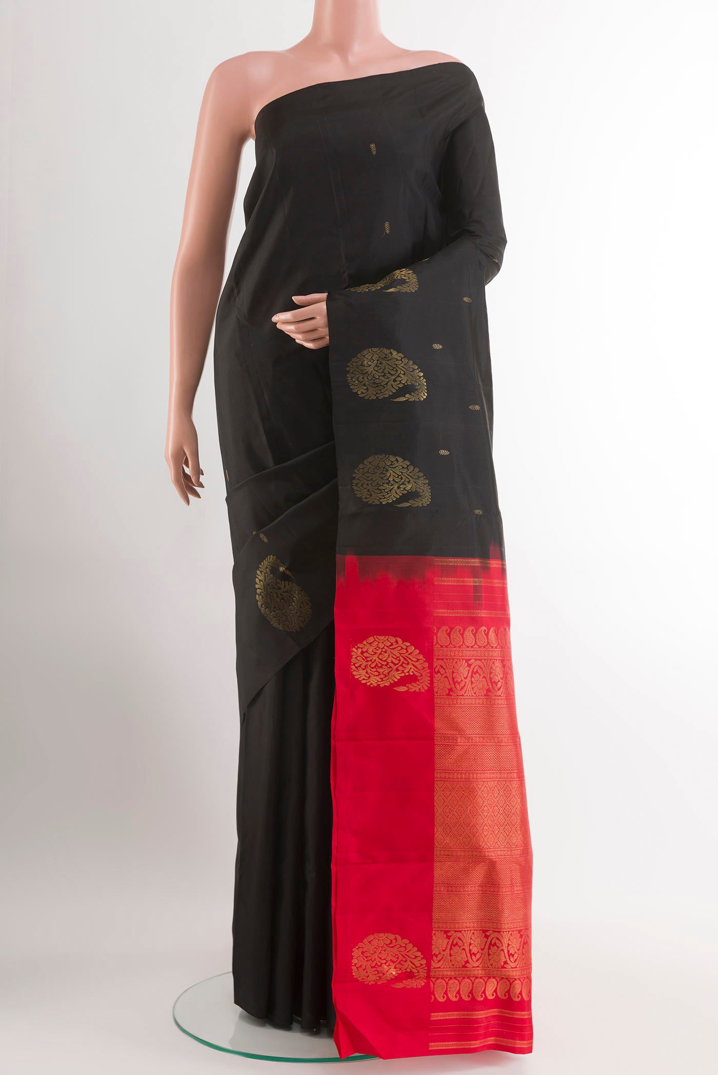 Black Kanchipuram Silk Saree with Zari Butta on the body and Zari Border.  displayed on a mannequin