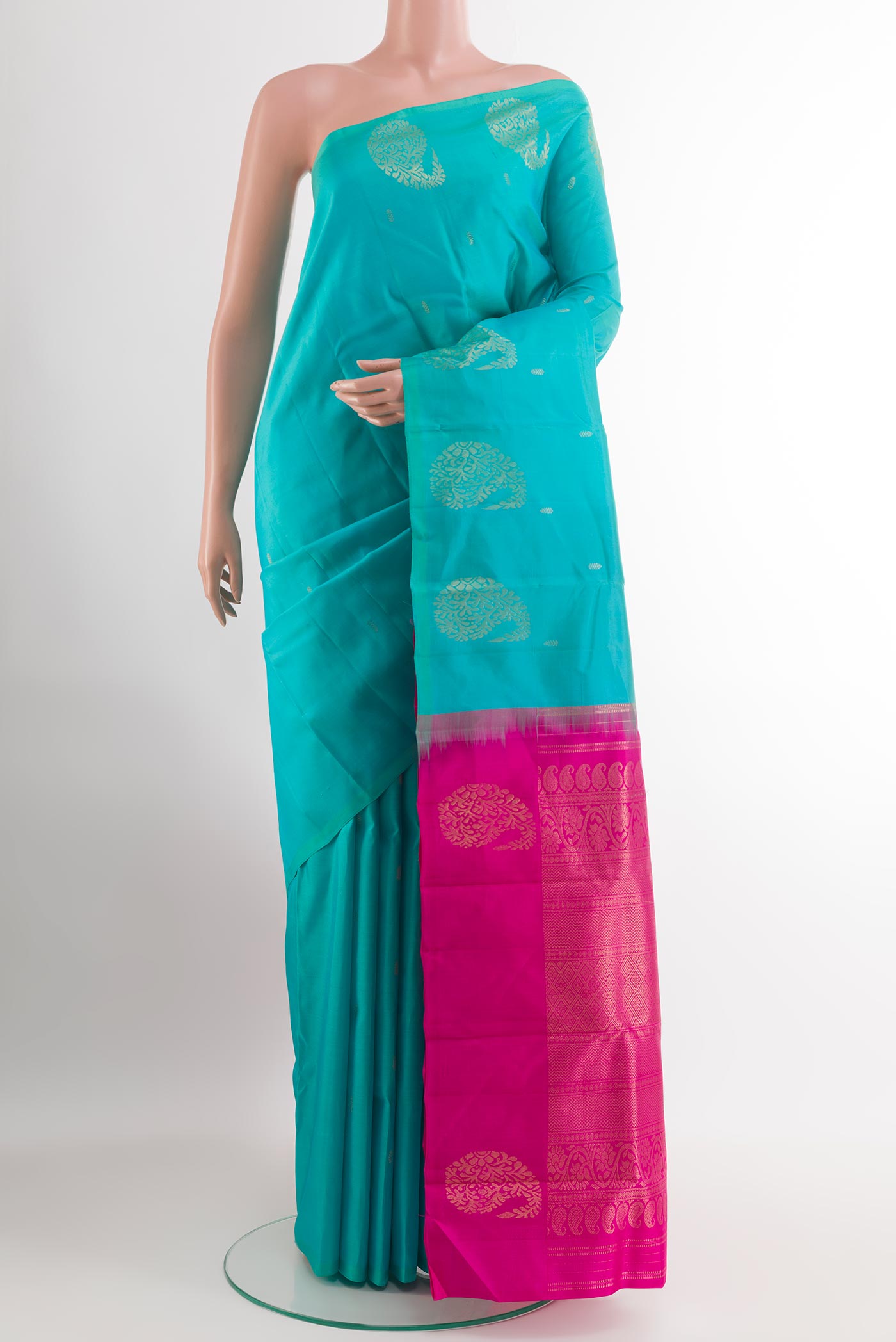Sea Green Kanchipuram Silk Saree with Zari Butta on the body and Zari Border.  displayed on a mannequin