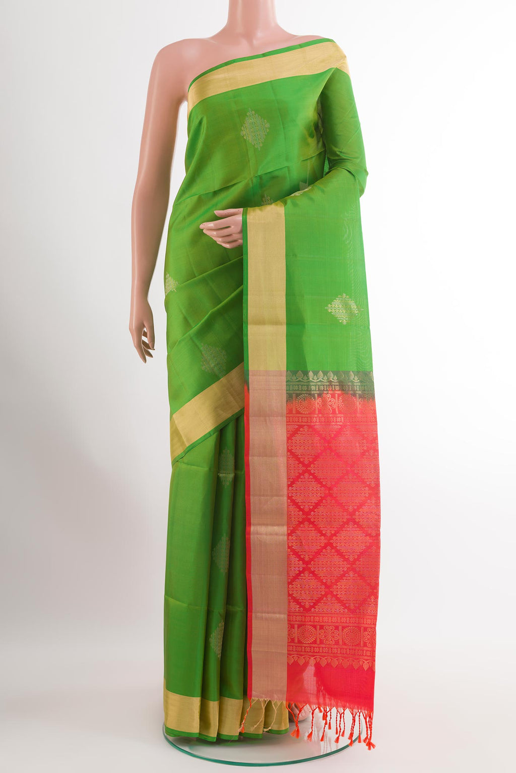 Green Soft Silk Saree with Zari Butta on the body and Zari Border.  displayed on a mannequin
