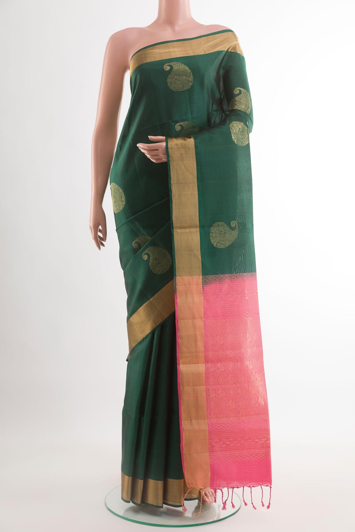 Bottle Green Soft Silk Saree with Zari Butta on the body and Zari Border.  displayed on a mannequin