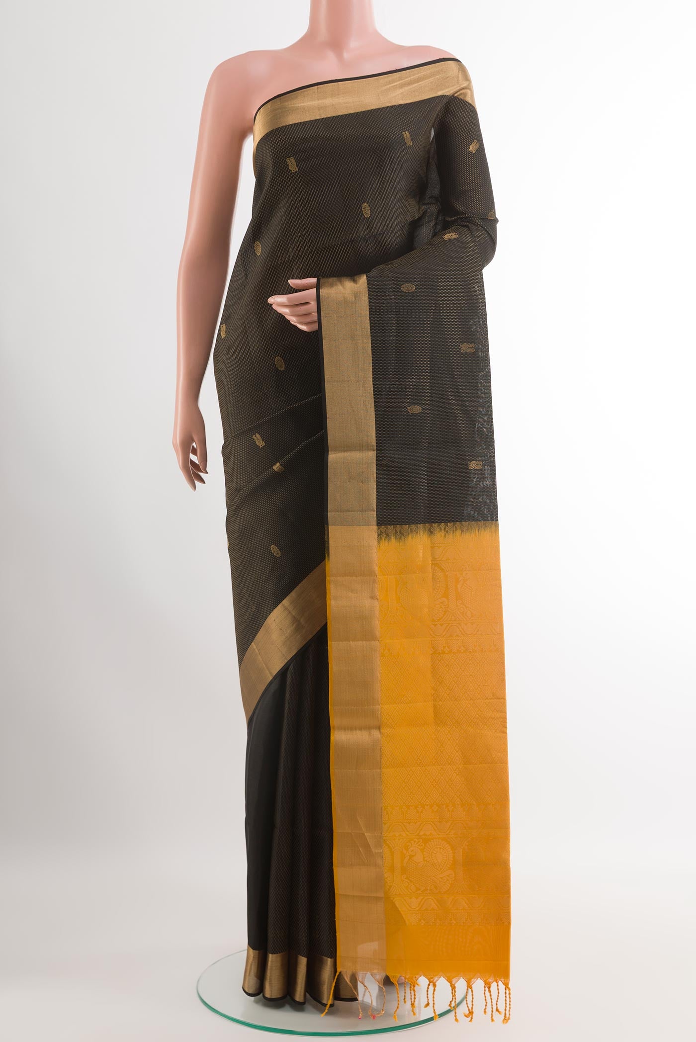 Black Soft Silk Saree with Zari Butta on the body and Zari Border.  displayed on a mannequin