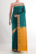 Sea Green Soft Silk Saree with Zari Butta on the body and Zari Border.  displayed on a mannequin
