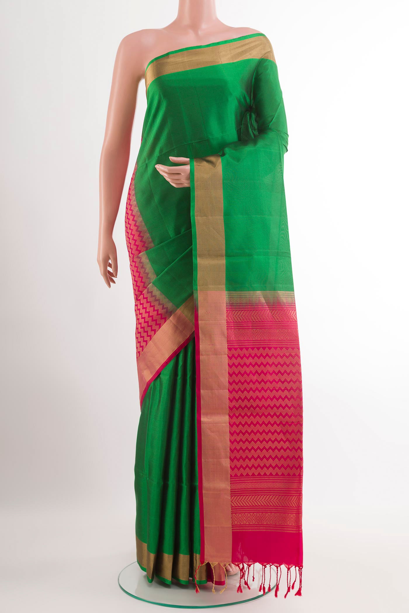 Green Soft Silk Saree with Plain Body and Zari Border.  displayed on a mannequin