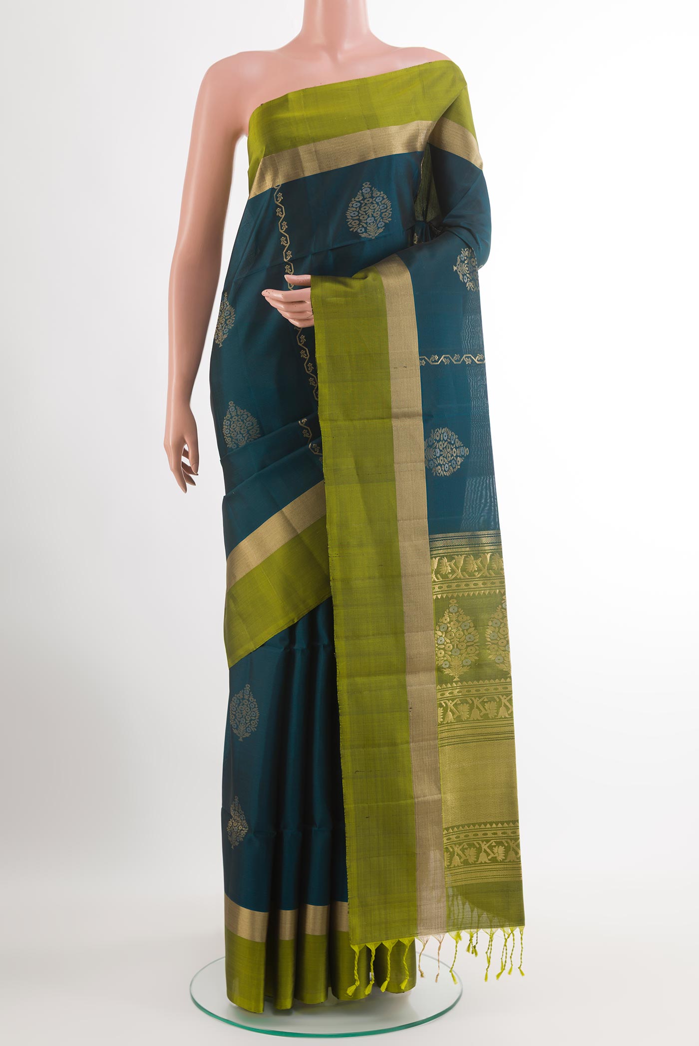 Teal Soft Silk Saree with Zari Butta on the body and Zari Border.  displayed on a mannequin