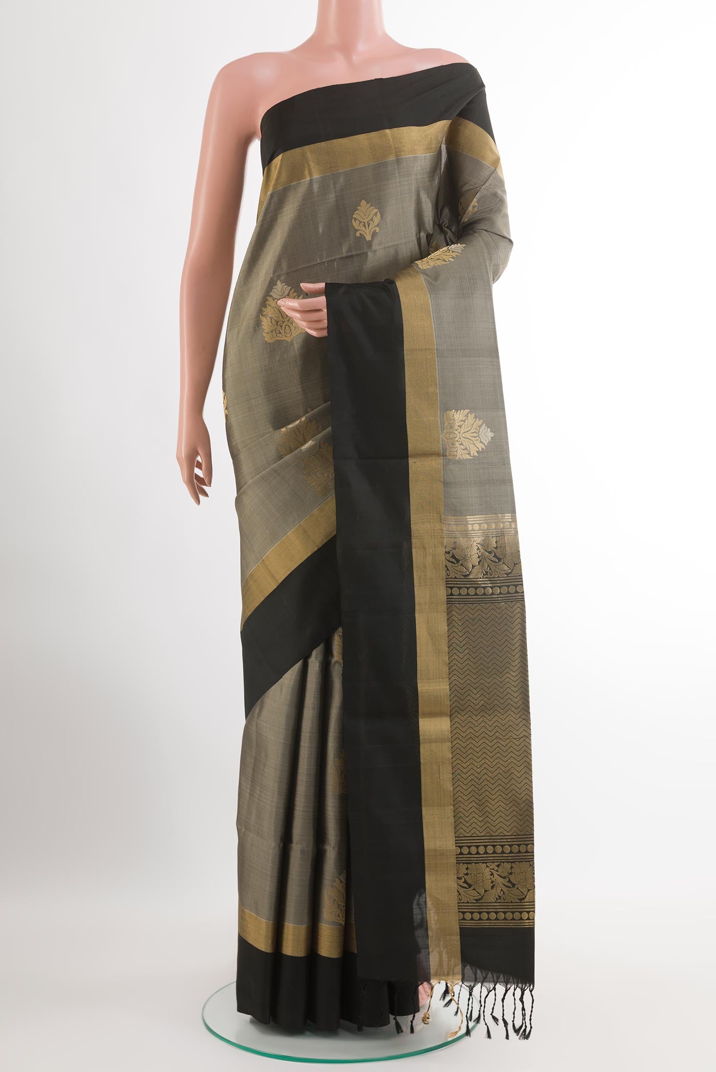 Grey Soft Silk Saree with Zari Butta on the body and Zari Border.  displayed on a mannequin