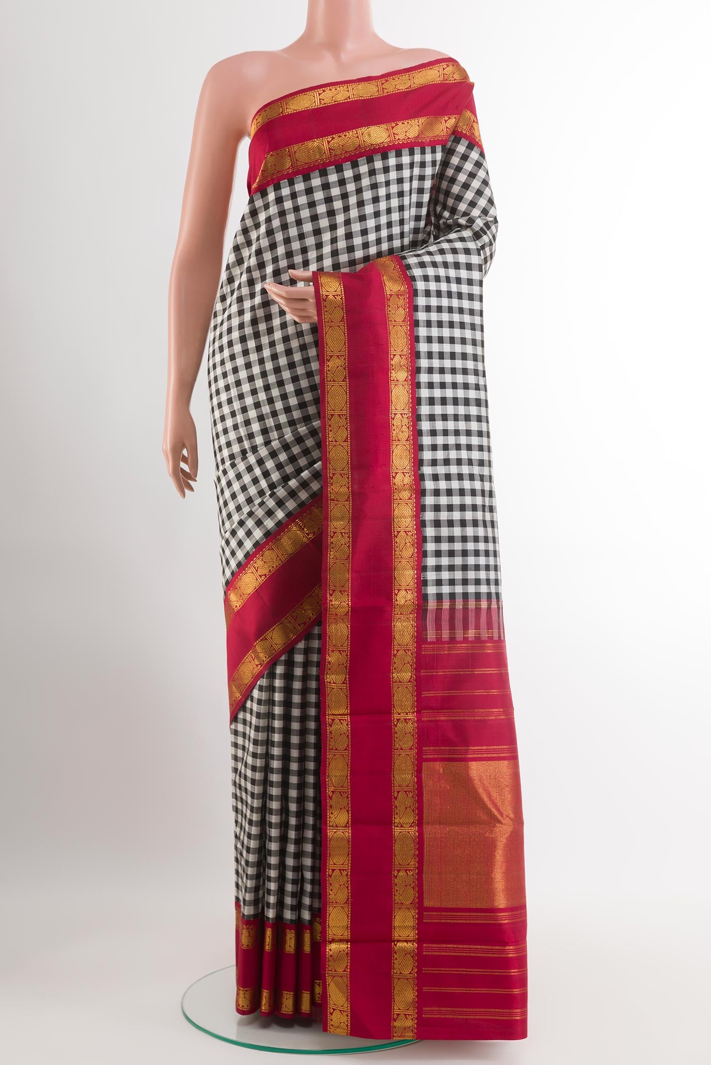 White Kanjivaram Silk Saree with Checked design on the body and Zari Border.  displayed on a mannequin