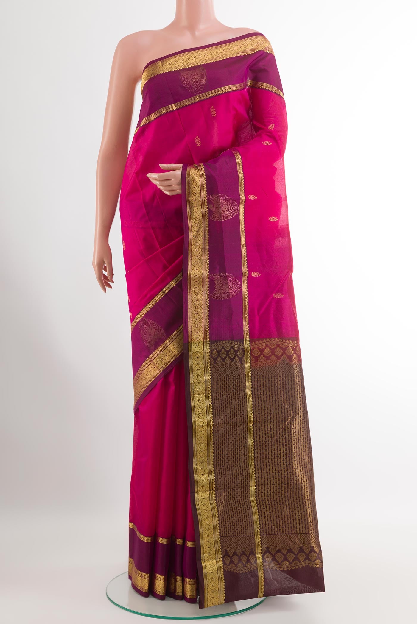 Pink Kanjivaram Silk Saree with Zari Butta on the body and Zari Border.  displayed on a mannequin