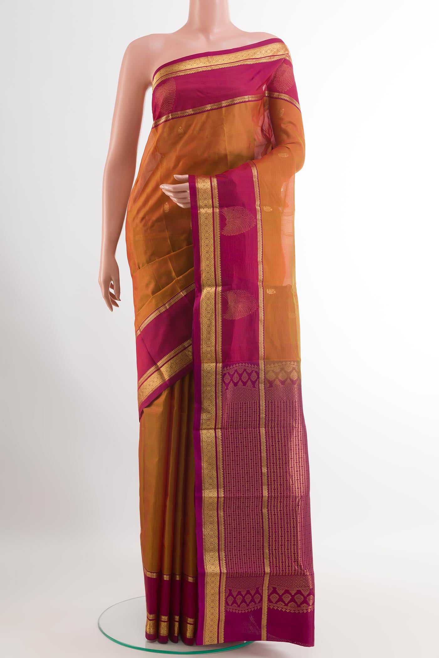 Orange Kanjivaram Silk Saree with Zari Butta on the body and Zari Border.  displayed on a mannequin